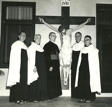 Carmelites with Bishop Buddy standing in front of crucifix 1953