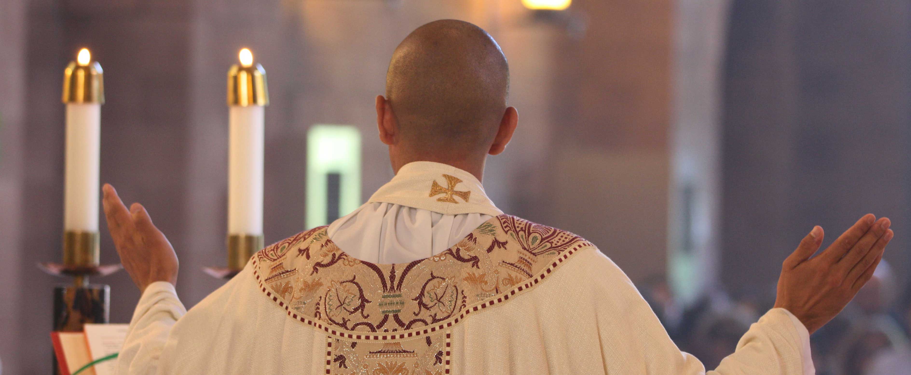 priest offering mass